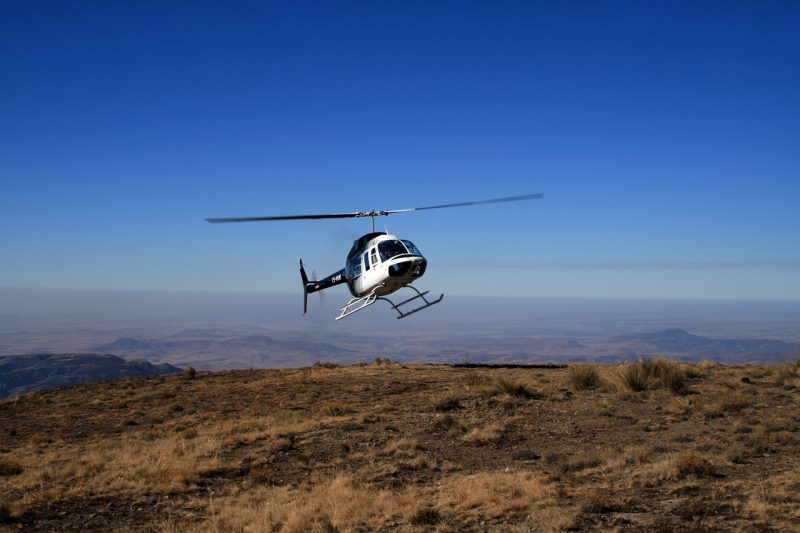A helicopter landing over an African mountain
