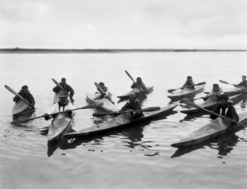 Inuit people using kayaks to hunt fishes