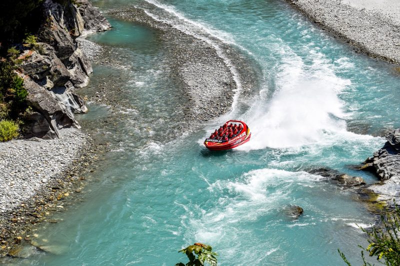 A jet boat speeds through the Shotover River