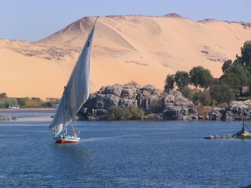 A boat sails along the banks of Aswan